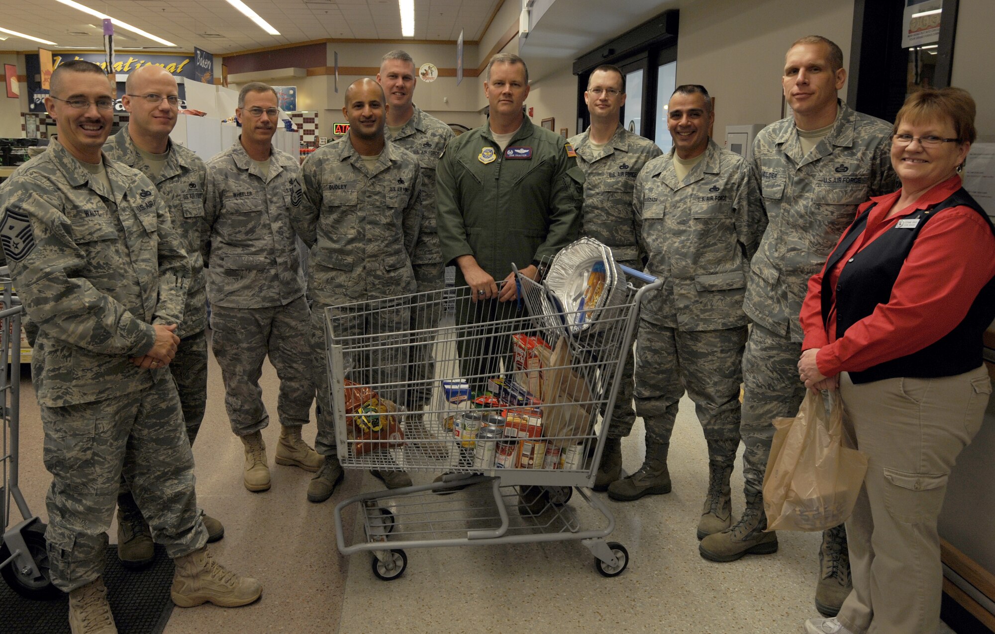 The Grand Forks Air Force Base First Sergeant Council poses with Col. Don Shaffer (center), 319th Air Refueling Wing commander, in front of a cart filled with donated items for Operation Warmheart, a Thanksgiving food drive hosted by the First Sergeant Council, Nov. 5 at the base commissary. The purpose of the food drive is to collect food donations so the council can assemble Thanksgiving meals for Grand Forks AFB Airmen to provide a no-cost holiday. Operation Warmheart is schedule to conclude Nov. 19. For more information on how to donate, contact Master Sgt. Aaron Mulder at (701) 747-4105 or Senior Master Sgt. Keith Waltz at (701) 747-5558. (U.S. Air Force photo by Staff Sgt. Suellyn Nuckolls)