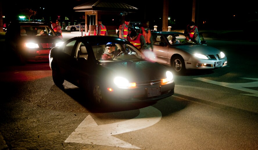 MOODY AIR FORCE BASE, Ga. -- Members of the 23rd Security Forces Squadron conduct sobriety checks as passengers leave base Nov. 5. The checks lasted for two hours and were designed to promote safe driving actions during the three-day weekend. (U.S. Air Force photo/Senior Airman Jamal D. Sutter)(RELEASED)