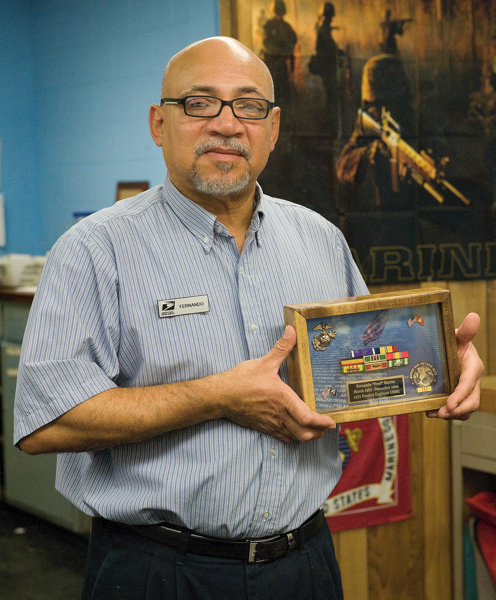 2 Nov 2010  USAF Photo by Jason Minto.  
Fernando Martin, USPS worker and the holder of two purple hearts receives a new ribbon case.
