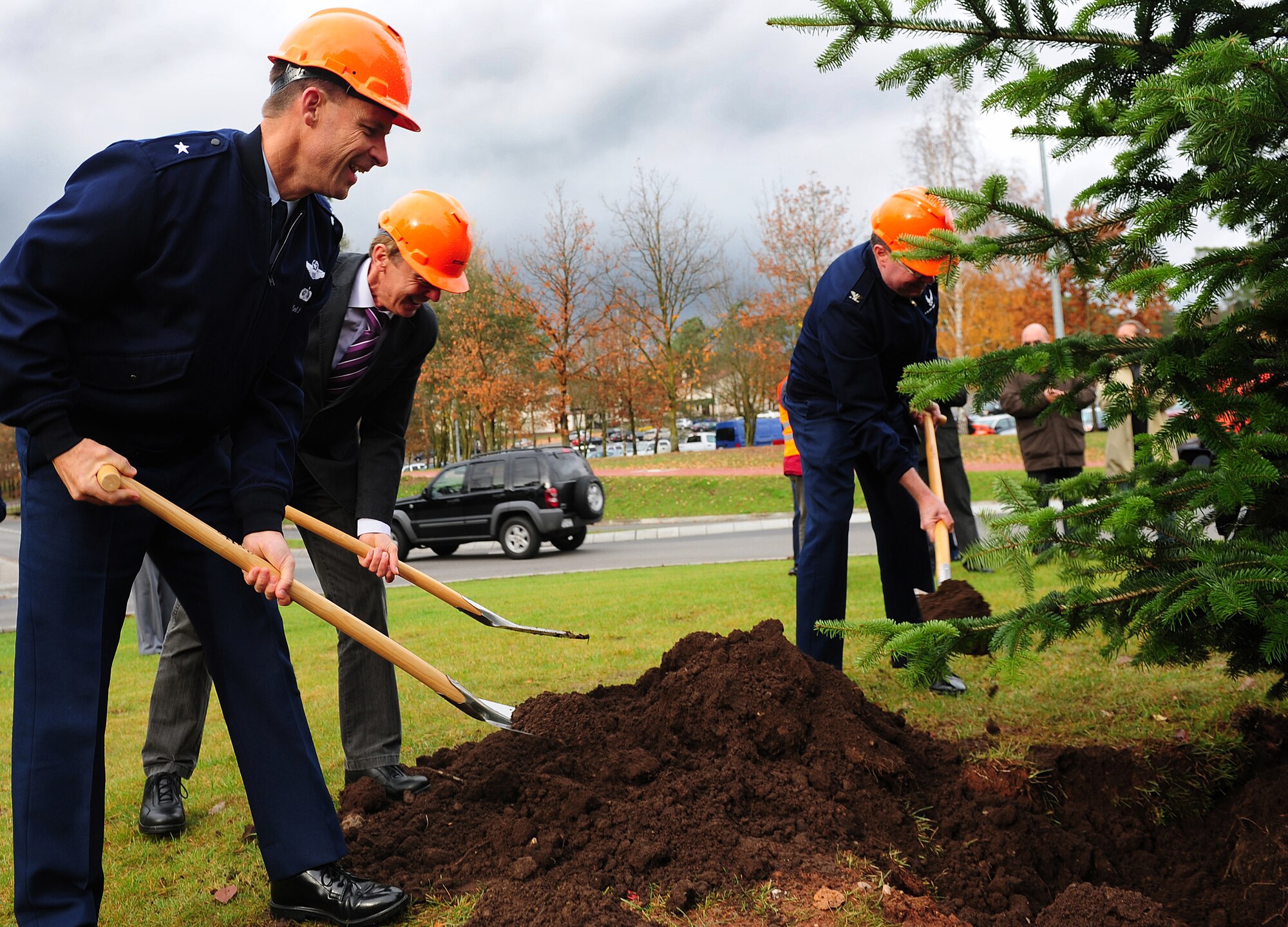 U.S. Air Force Brig. Gen. Mark Dillon (left), 86th Airlift Wing commander, Klaus Layes (middle), Ramstein-Miesenbach mayor, and Col. Harry Mathis (right), 86th Airlift Wing Headquarters Chaplin, shovel dirt into the roots of Ramstein's permanent installation Christmas tree, Ramstein Air Base, Germany, Nov. 8, 2010. The City of Ramstein-Miesenbach has donated the tree to symbolize the long partnership and close cooperation between the German and American communities. (U.S. Air Force photo by Airman 1st Class Brea Miller)