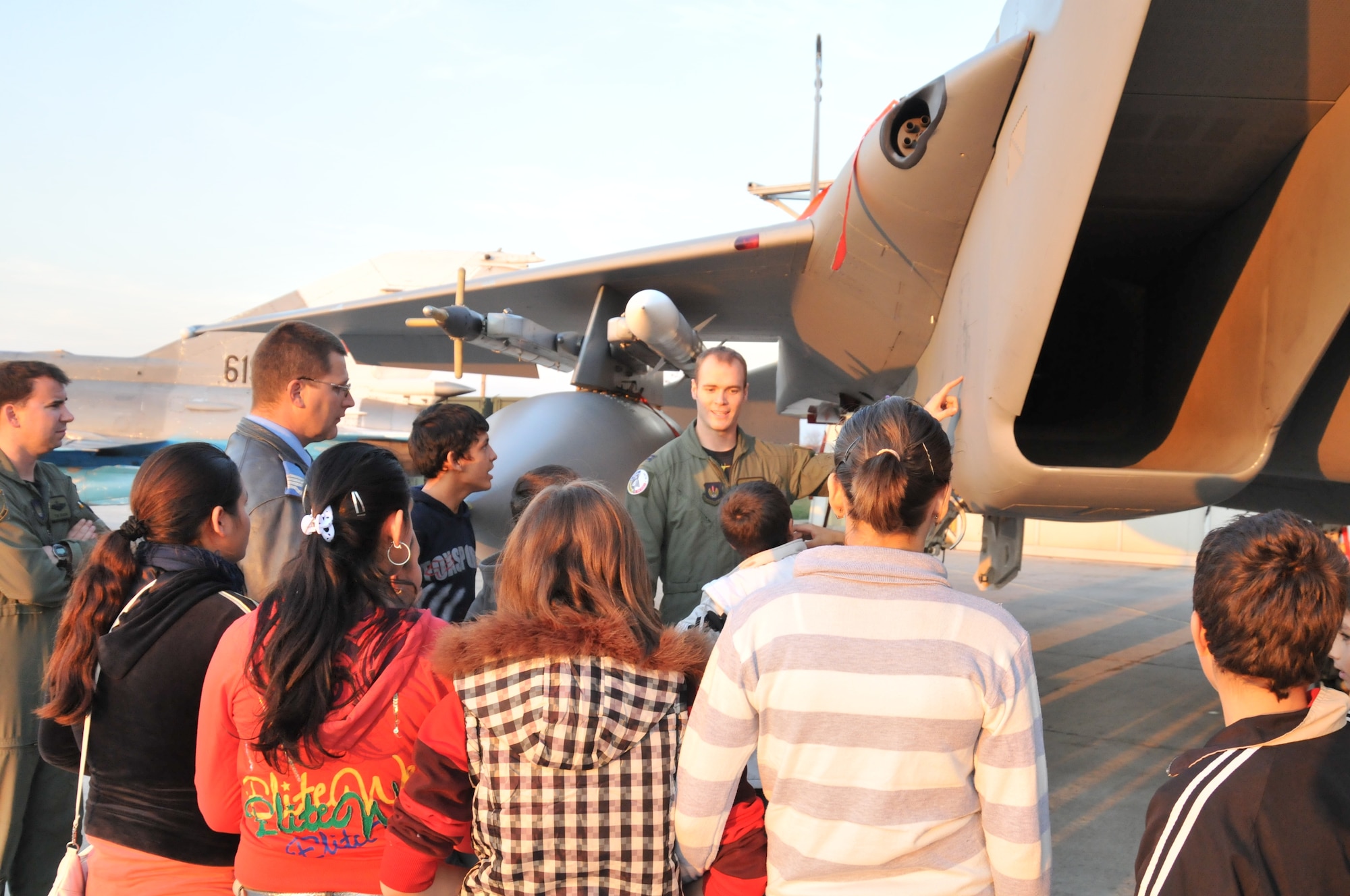 CAMPIA TURZII AIR BASE, Romania - Capt. Neils Barner, 493rd Fighter Squadron pilot, describes an F-15C Eagle to a group of Romanian school children  Nov. 5. The children visited from a local youth center where Airmen had volunteered to play games and perform repairs. (U.S. Air Force photo/Senior Airman David Dobrydney)
