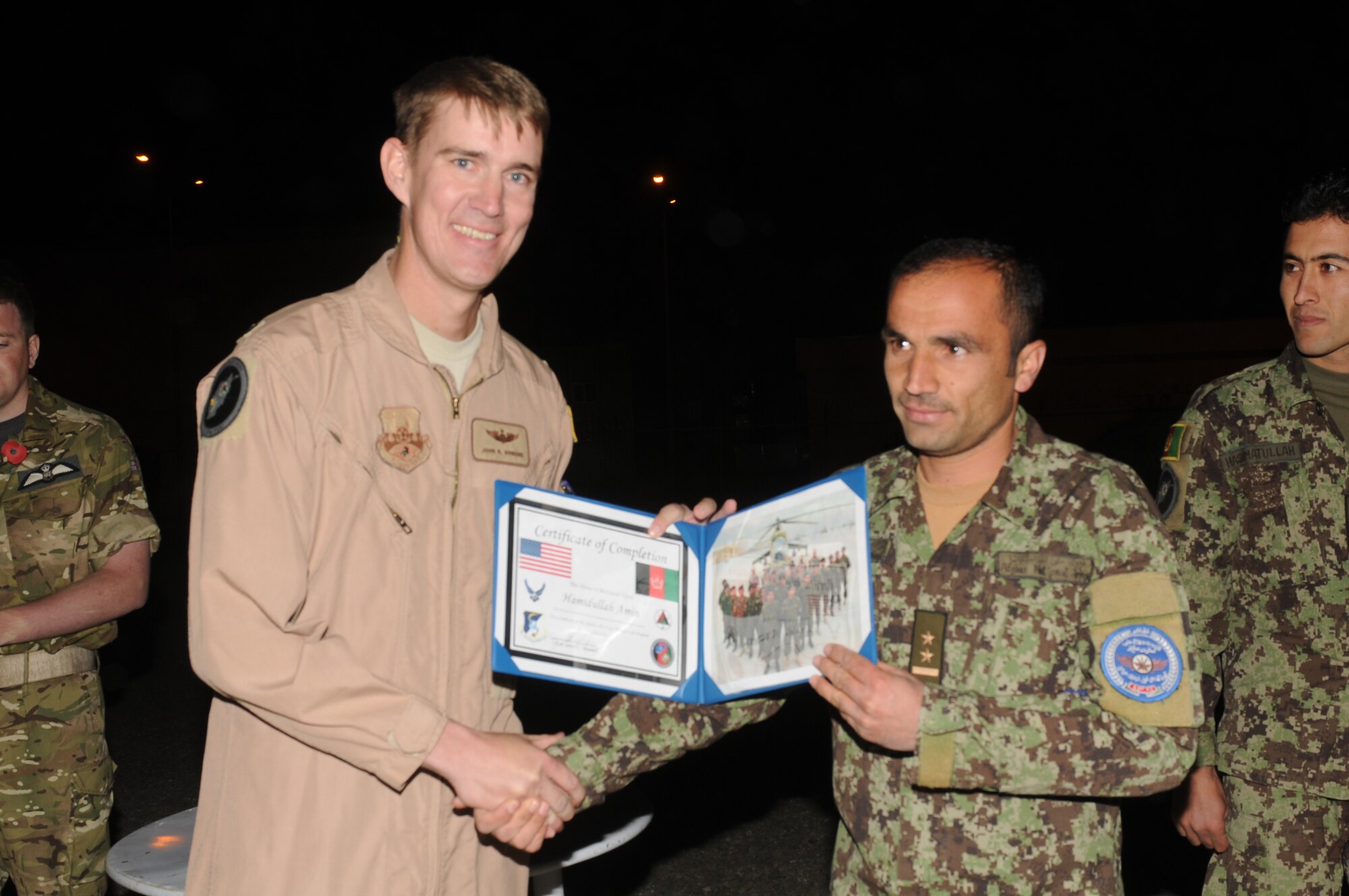 KABUL, Afghanistan - Lt. Col. John Howard, the Officer-In-Charge of the Thunder Lab present the 14 graduating members their certificates on Nov 7. (U.S. Air Force photo by Capt. Rob Leese/ RELEASED).
