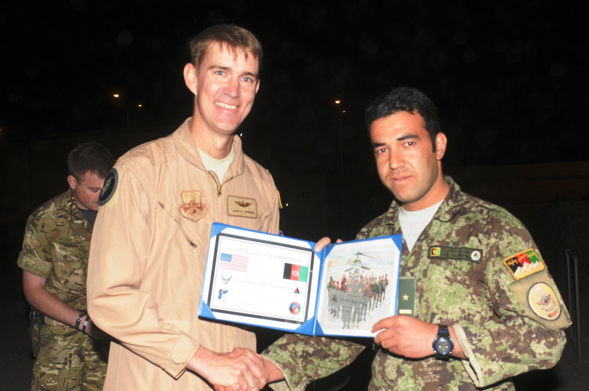 KABUL, Afghanistan - Lt. Col. John Howard, the Officer-In-Charge of the Thunder Lab present the 14 graduating members their certificates on Nov 7. (U.S. Air Force photo by Capt. Rob Leese/ RELEASED).
