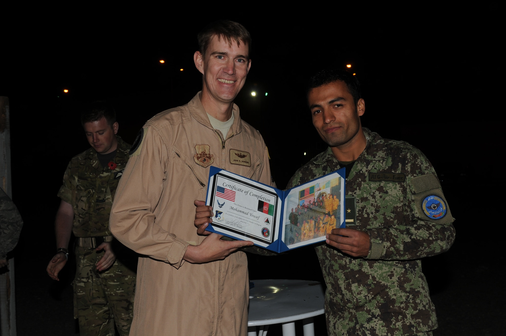 KABUL, Afghanistan - Lt. Col. John Howard, the Officer-In-Charge of the Thunder Lab present the 14 graduating members their certificates on Nov 7. (U.S. Air Force photo by Capt. Rob Leese/ RELEASED).
