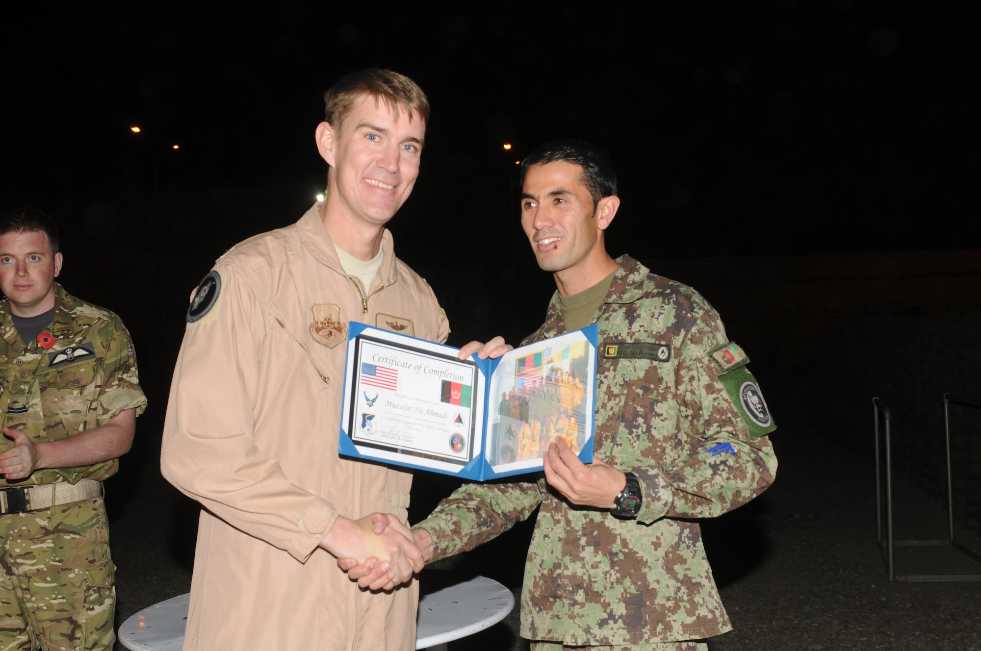 KABUL, Afghanistan - Lt. Col. John Howard, the Officer-In-Charge of the Thunder Lab present the 14 graduating members their certificates on Nov 7. (U.S. Air Force photo by Capt. Rob Leese/ RELEASED).
