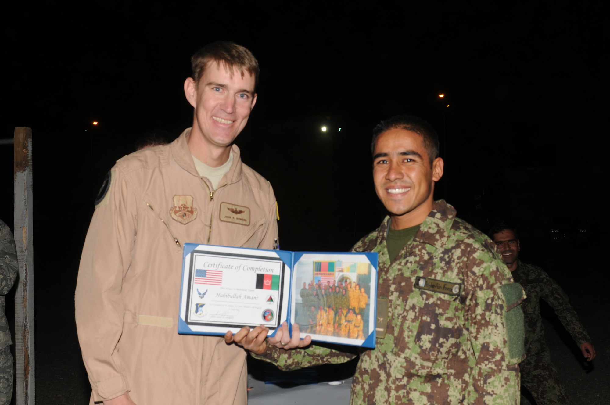 KABUL, Afghanistan - Lt. Col. John Howard, the Officer-In-Charge of the Thunder Lab present the 14 graduating members their certificates on Nov 7. (U.S. Air Force photo by Capt. Rob Leese/ RELEASED).
