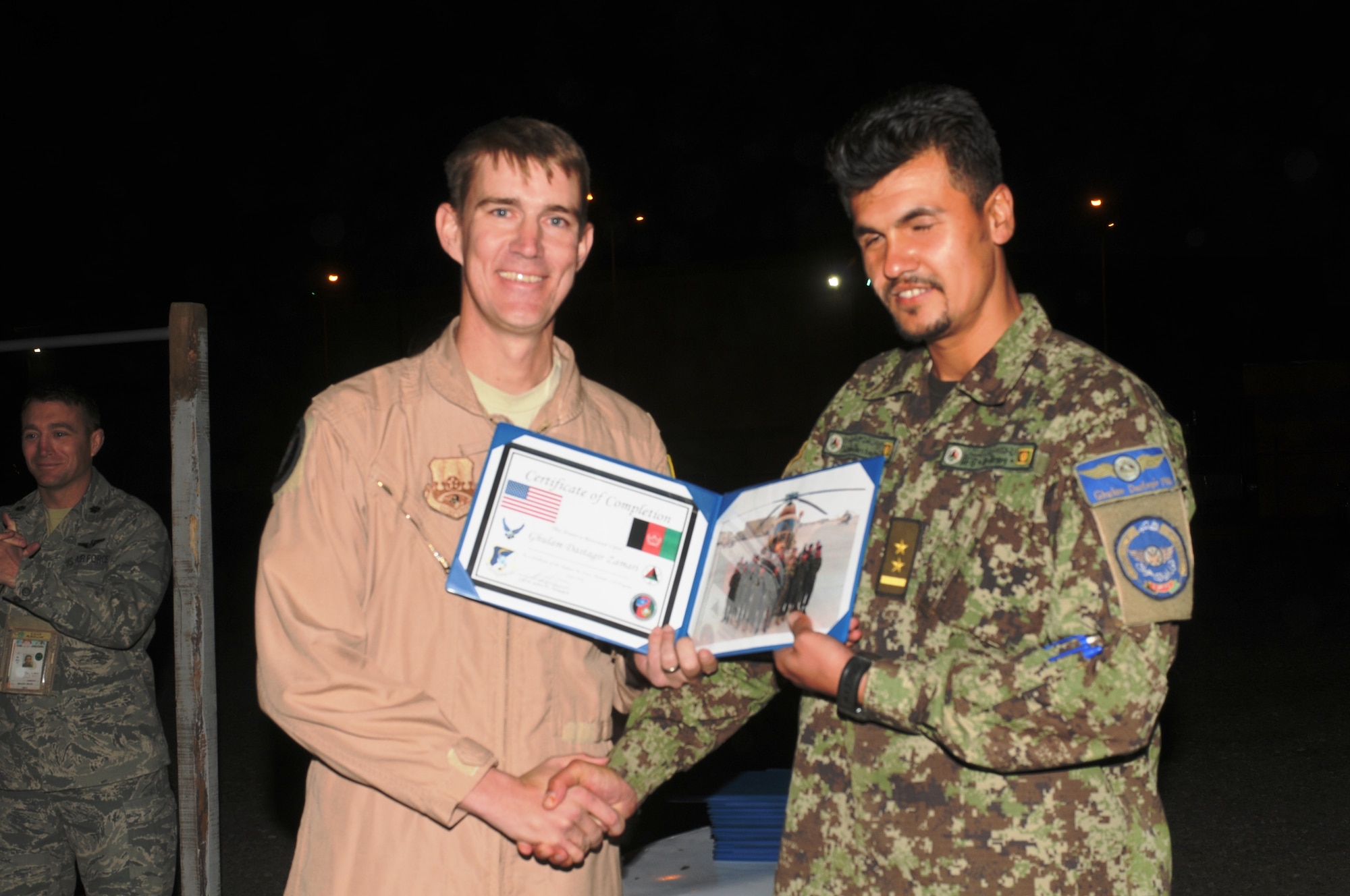 KABUL, Afghanistan - Lt. Col. John Howard, the Officer-In-Charge of the Thunder Lab present the 14 graduating members their certificates on Nov 7. (U.S. Air Force photo by Capt. Rob Leese/ RELEASED).
