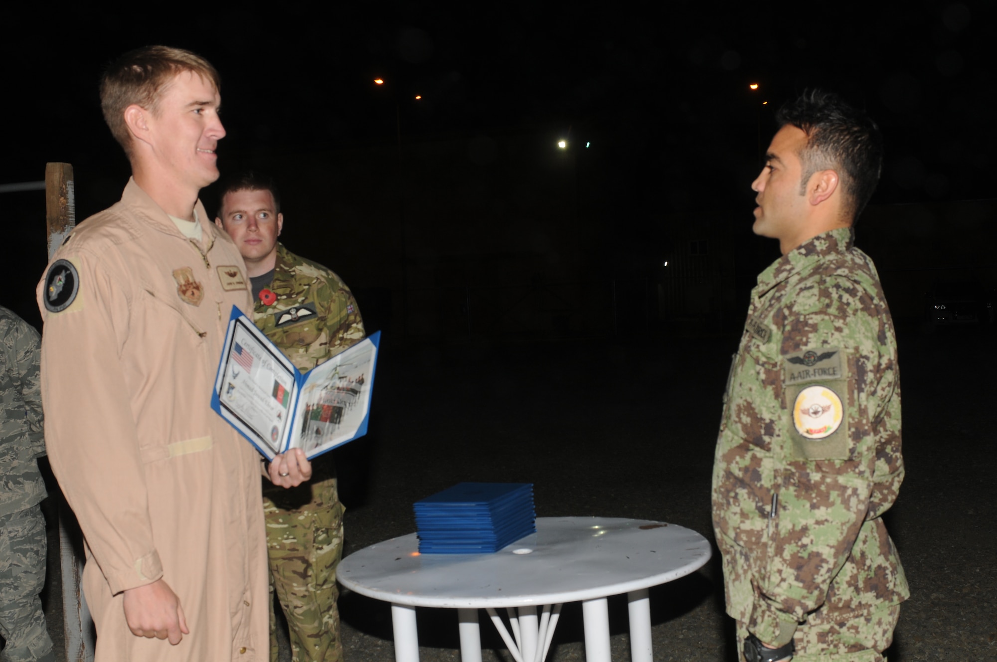 KABUL, Afghanistan - Lt. Col. John Howard, the Officer-In-Charge of the Thunder Lab present the 14 graduating members their certificates on Nov 7. (U.S. Air Force photo by Capt. Rob Leese/ RELEASED).
