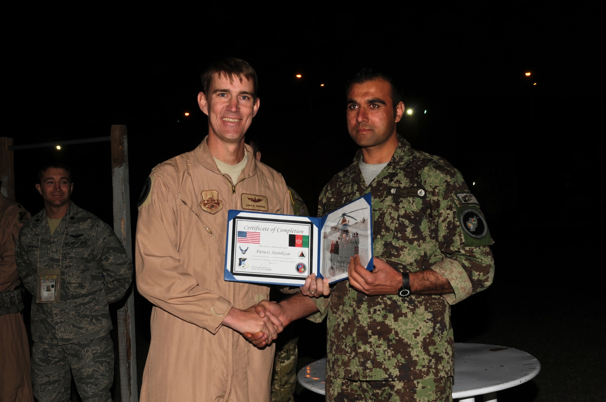 KABUL, Afghanistan - Lt. Col. John Howard, the Officer-In-Charge of the Thunder Lab present the 14 graduating members their certificates on Nov 7. (U.S. Air Force photo by Capt. Rob Leese/ RELEASED).
