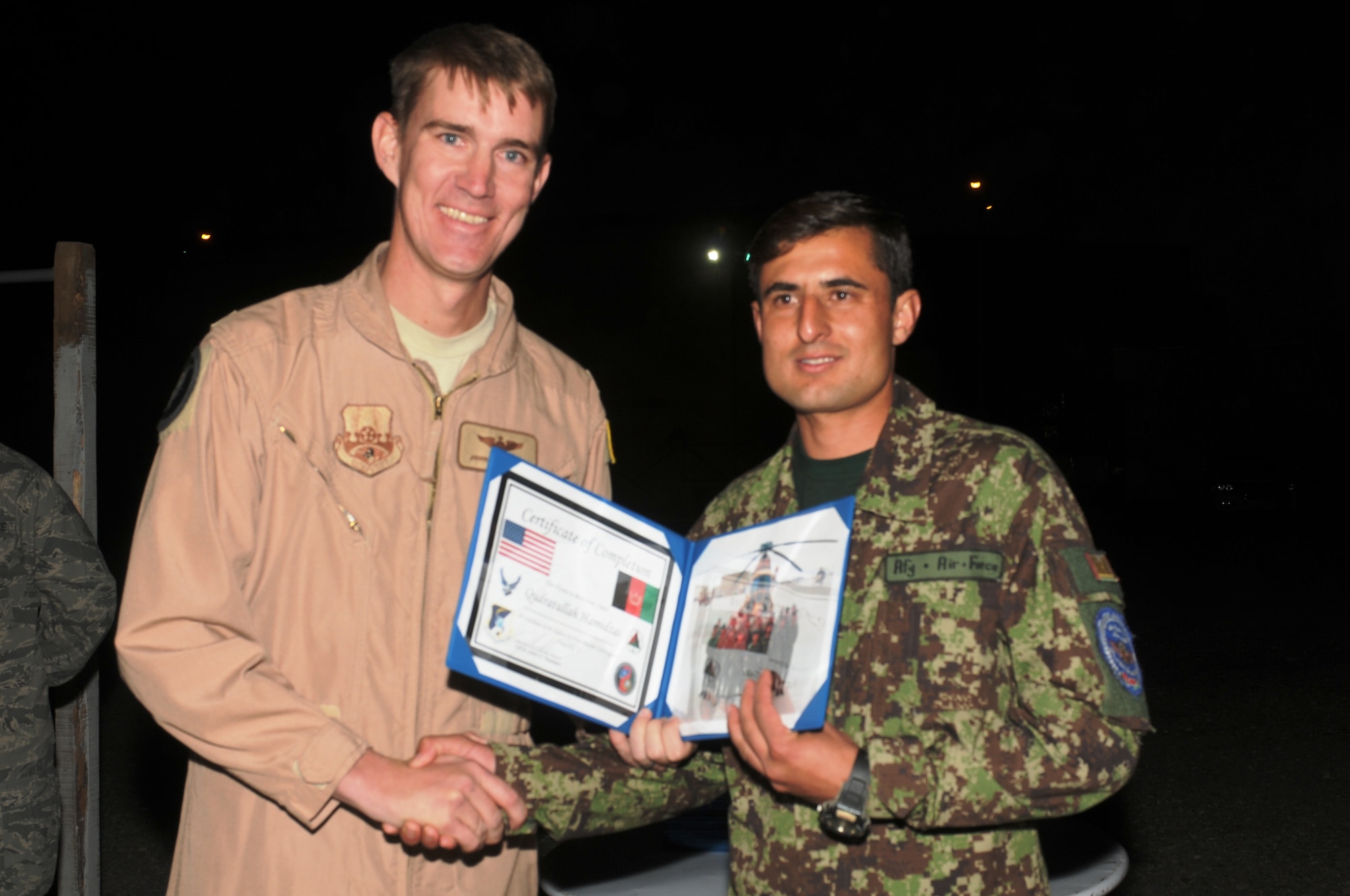 KABUL, Afghanistan - Lt. Col. John Howard, the Officer-In-Charge of the Thunder Lab present the 14 graduating members their certificates on Nov 7. (U.S. Air Force photo by Capt. Rob Leese/ RELEASED).
