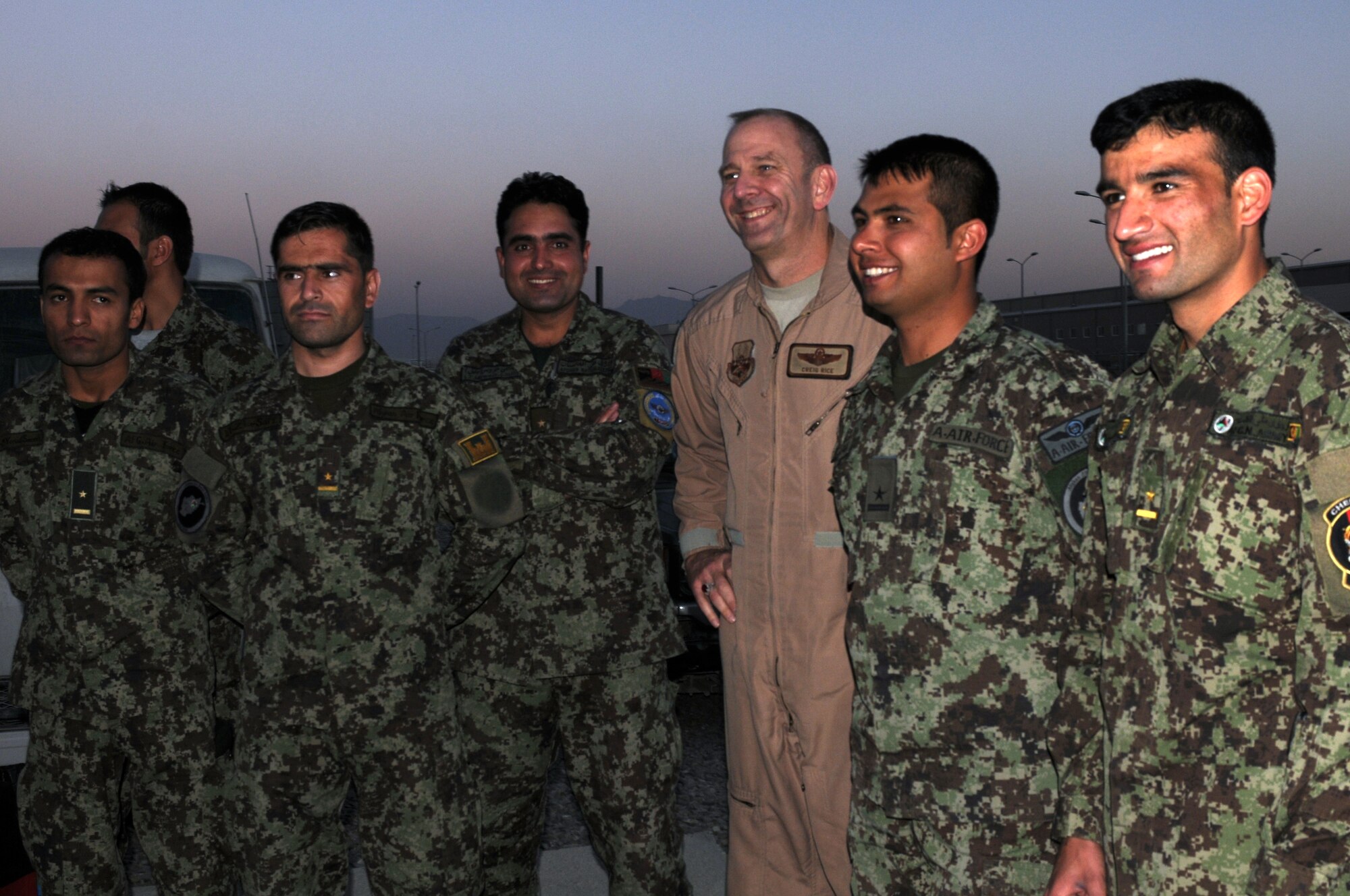 KABUL, Afghanistan - Col. Creig Rice and the Afghan Air Force’s Thunder Lab Lieutenants  celebrates the graduation of 14 pilot candidates who will now proceed to more advanced training in the U.S. (U.S. Air Force photo by Capt. Rob Leese/ RELEASED).
