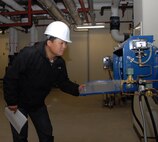 KUNSAN AIR BASE, Republic of Korea -- Kim Yong-Sik, 8th CES construction inspector, checks boiler room machinery in a new dormitory building under construction here. Mr. Kim was recently named the 2010 U.S. Forces Korea Technician of the Year for the annual USFK Civilian Employee of the Year awards. (U.S. Air Force photo/Staff Sgt. Amanda Savannah)