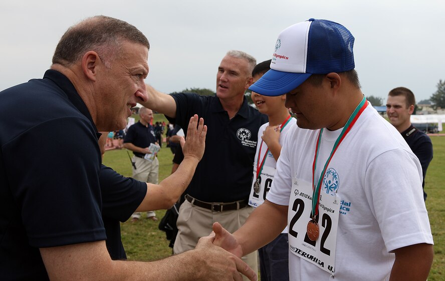 Gen. Gary North, Pacific Air Forces commander, congratulates an athlete during the 11th Annual Kadena Special Olympics Nov. 6.  General North supported the second and third annual games during his tenure as 18th Wing commander from 2000 to 2002. (Courtesy photo by Chip Steitz)
