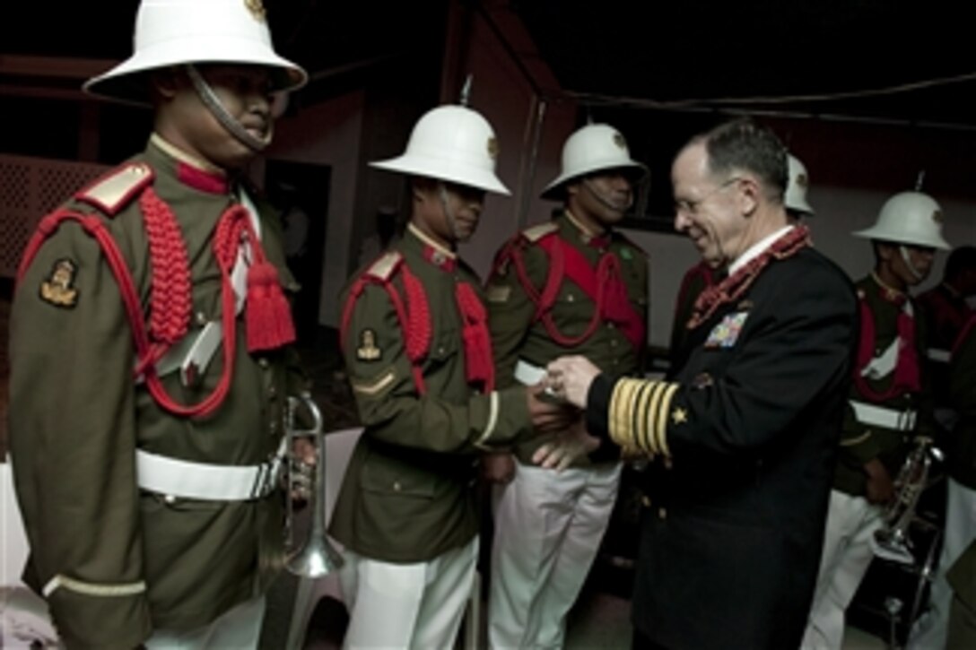 Chairman of the Joint Chiefs of Staff Adm. Mike Mullen, U.S. Navy, greets Tongan Honor Guard soldiers during a visit to the kingdom on Nov. 9, 2010.  Mullen visited Tonga on the second stop of a Pacific tour to thank the Tongan people for their continuing dedication and support in sending troops to Iraq and Afghanistan.  