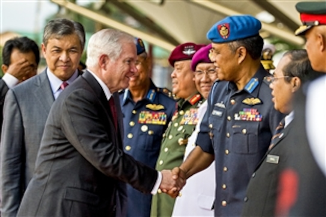 U.S. Defense Secretary Robert M. Gates shakes hands with Malaysian defense officials as he leaves the Defense Ministry building in Kuala Lumpur, Malaysia, Nov. 9, 2010.   
