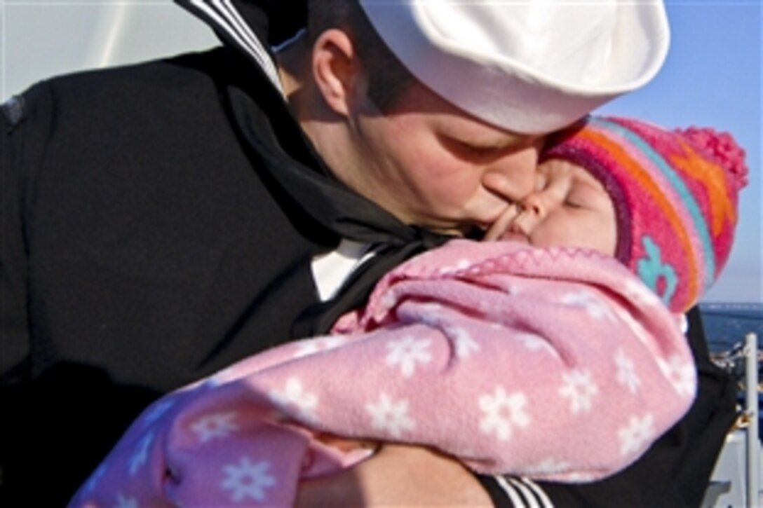 U.S. Navy Petty Officer 3rd Class Carl Perry kisses his 4-month-old daughter good-bye aboard the guided-missile destroyer USS Mahan at Naval Station Norfolk, Nov. 7, 2010. The guided-missile destroyer is leaving on a six-month deployment to the U.S. 6th Fleet area of responsibility to conduct maritime security operations.