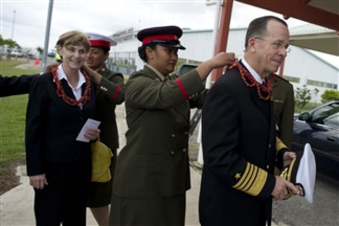 Chairman of the Joint Chiefs of Staff Adm. Mike Mullen, U.S. Navy, and his wife Deborah are presented leis after their arrival in the Kingdom of Tonga on Nov. 9, 2010.  The Mullen's stopped in Tonga on the second stop of a Pacific tour to thank the Tongan people for their continuing dedication and support in sending troops to Iraq and Afghanistan.  