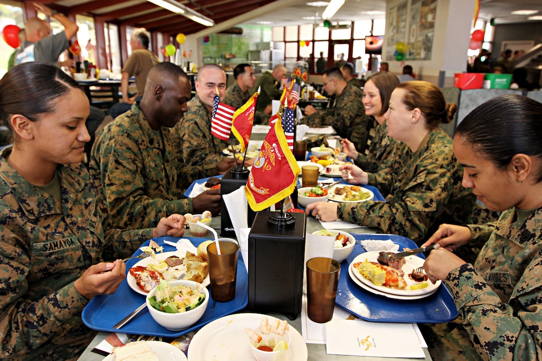 Camp Pendleton Marines sit and enjoy a lobster and steak meal at base's 24 Area Mess Hall in celebration of the Corps 235th Birthday, Nov. 9. Marines, sailors and civilians patiently waited outside the mess hall's doors to enjoy the ample lobster, steak, breaded shrimp, baked potatoes, French onion soup, shrimp cocktail, deviled eggs, salad and most importantly, birthday cake. Each year, on the Marine Corps birthday of Nov. 10, Marines exemplify camaraderie by celebrating the establishment of their service and even sharing a midday meal with each other.