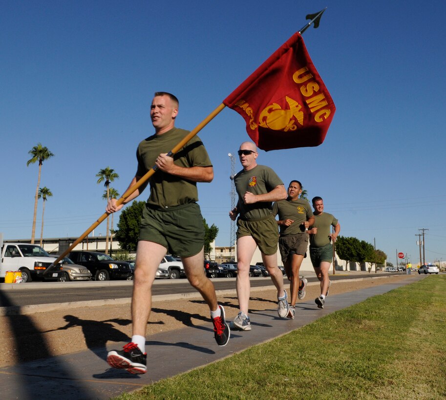 Staff Sgt. Ryan Brown, Marine Aviation Logistics Squadron 13 ground safety manager, carries Marine Aircraft Group 13’s guidon and leads other MALS-13 Marines Nov. 9, 2010, during the MAG-13 Marine Corps birthday run, which started at 2 a.m. and finished at 8 a.m. Nov. 10, 2010. Groups of Marines, ranging from one to small groups at a time, took turns completing three laps each around the station parade field, which is approximately 1.4 miles, to compile a total of 235 miles. Each mile represented a year the Marine Corps has existed.