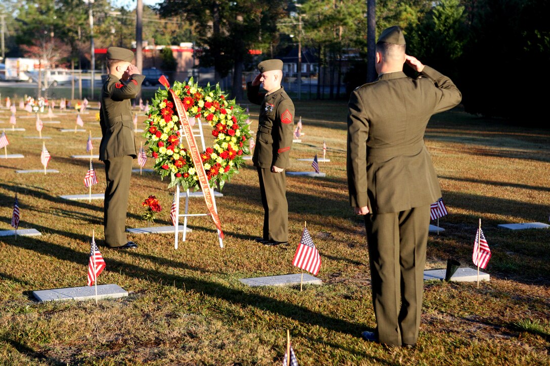 Elements of Headquarters and Support Battalion, Marine Corps Base Camp Lejeune render salutes to a wreath in honor of Timothy McHugh, third sergeant major of the Marine Corps, during a wreath-laying ceremony at the Coastal Carolina State Veterans Cemetery, Nov. 10. As set forth by the Marine Corps Casualty Procedures Manual, wreaths are to be placed at the graves of all former commandants and sergeants major of the Marine Corps, no matter where in the world they have been laid to rest.