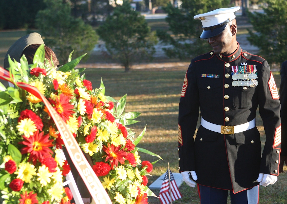 Sgt. Maj. Michael Jones, sergeant major of the 2nd Marine Division, looks upon the grave of Timothy McHugh, third sergeant major of the Marine Corps, during a wreath-laying ceremony at the Coastal Carolina State Veterans Cemetery, Nov. 10. As set forth by the Marine Corps Casualty Procedures Manual, wreaths are to be placed at the graves of all former commandants and sergeants major of the Marine Corps, no matter where in the world they have been laid to rest.