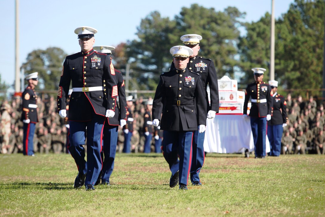 MARINE CORPS BASE CAMP LEJEUNE, N.C. - Col. Daniel J. Lecce, commanding officer of Marine Corps Base Camp Lejeune, (right), and Sgt. Maj. William C. Rice, (left), sergeant major of Marine Corps Base Camp Lejeune, along with the youngest and oldest Marines walk off the field after conducting the cake cutting ceremony during the Joint Daytime Ceremony honoring the Marine Corps' birthday aboard Marine Corps Base Camp Lejeune, Nov. 10. Every year Marines across the world celebrate the birthday with cheer and enthusiasm and proudly carry on the tradition of Semper Fidelis.