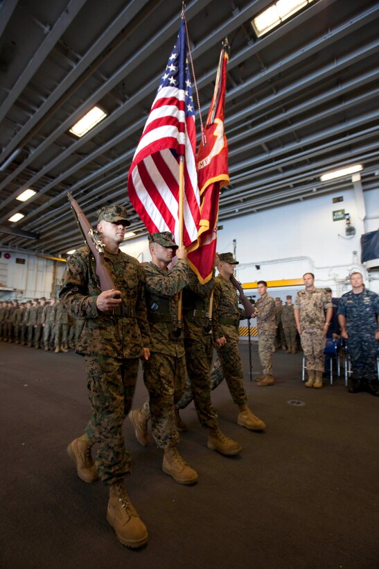 U.S. color guard Marines with Special-Purpose Marine Air-Ground Task Force Continuing Promise 2010 march forward to commence the Marine Corps 235th birthday celebration in the hangar bay of the amphibious assault ship USS Iwo Jima, Nov. 10, 2010. Service members and civilians are deployed in support of CP10 providing medical, dental, veterinary, engineering assistance and subject-matter exchanges to Caribbean, Central and South American nations. Service members and civilians are currently off the coast of Cuba.