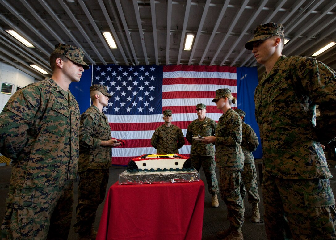 U.S. Marines with Special-Purpose Marine Air-Ground Task Force Continuing Promise 2010, prepare to cut birthday cake during the Marine Corps 235th birthday celebration in the hangar bay of the amphibious assault ship USS Iwo Jima, Nov. 10, 2010. Service members and civilians are deployed in support of CP10 providing medical, dental, veterinary, engineering assistance and subject-matter exchanges to Caribbean, Central and South America. Service members and civilians are currently off the coast of Cuba.