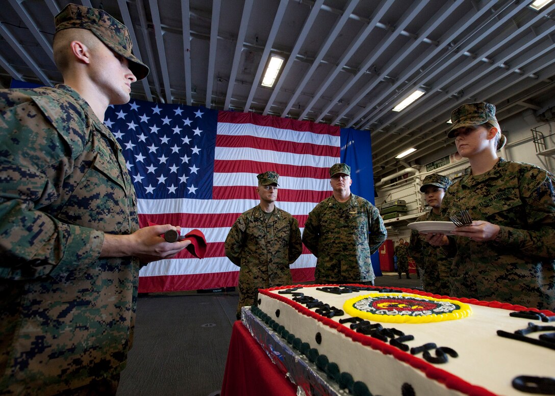 U.S. Marines with Special-Purpose Marine Air-Ground Task Force Continuing Promise 2010, prepare to cut birthday cake during the Marine Corps 235th birthday celebration in the hangar bay of the amphibious assault ship USS Iwo Jima, Nov. 10, 2010. Service members and civilians are deployed in support of CP10 providing medical, dental, veterinary, engineering assistance and subject-matter exchanges to Caribbean, Central and South American nations. Service members and civilians are currently off the coast of Cuba.
