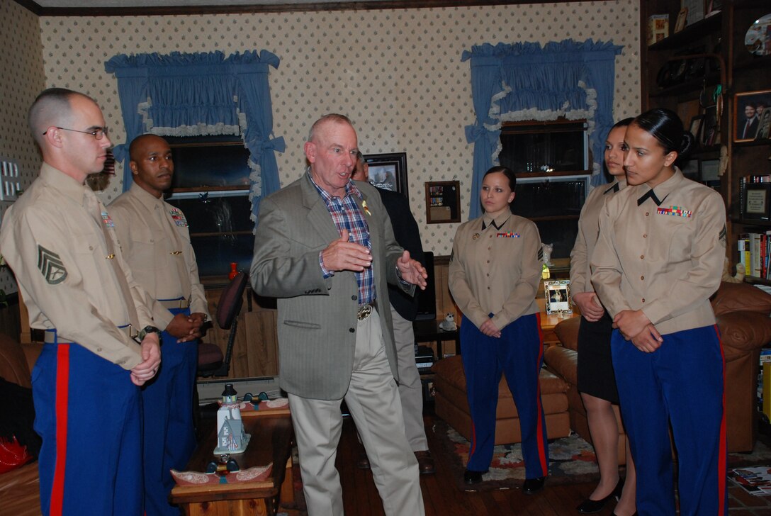 Retired Sgt. Maj. Harold G. Overstreet, center, the 12th Sergeant Major of the Marine Corps, shares a story with fellow Marines at the home of the 7th SMMC, retired Sgt. Maj. Henry H. Black.  Overstreet shared how he was on recruiting duty as a gunnery sergeant and petitioned Black for orders to the drill field, and two weeks later, his request was granted.