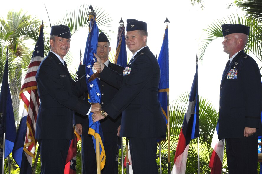 Col. Allan Kollien (center) assumes command of the 613th Air And Space Operations Center at Joint Base Pearl Harbor-Hickam, Hawaii, on Nov. 11, 2010.  Colonel Kollien, who was previously the 613th AOC vice commander, will as commander,  lead  one of five AN/USQ-163 FALCONER weapon systems worldwide through which a commander of Air Force Forces or a joint force air component commander exercises command and control of air, space, and information forces.  (Air Force photo/ David D. Underwood, Jr.) 