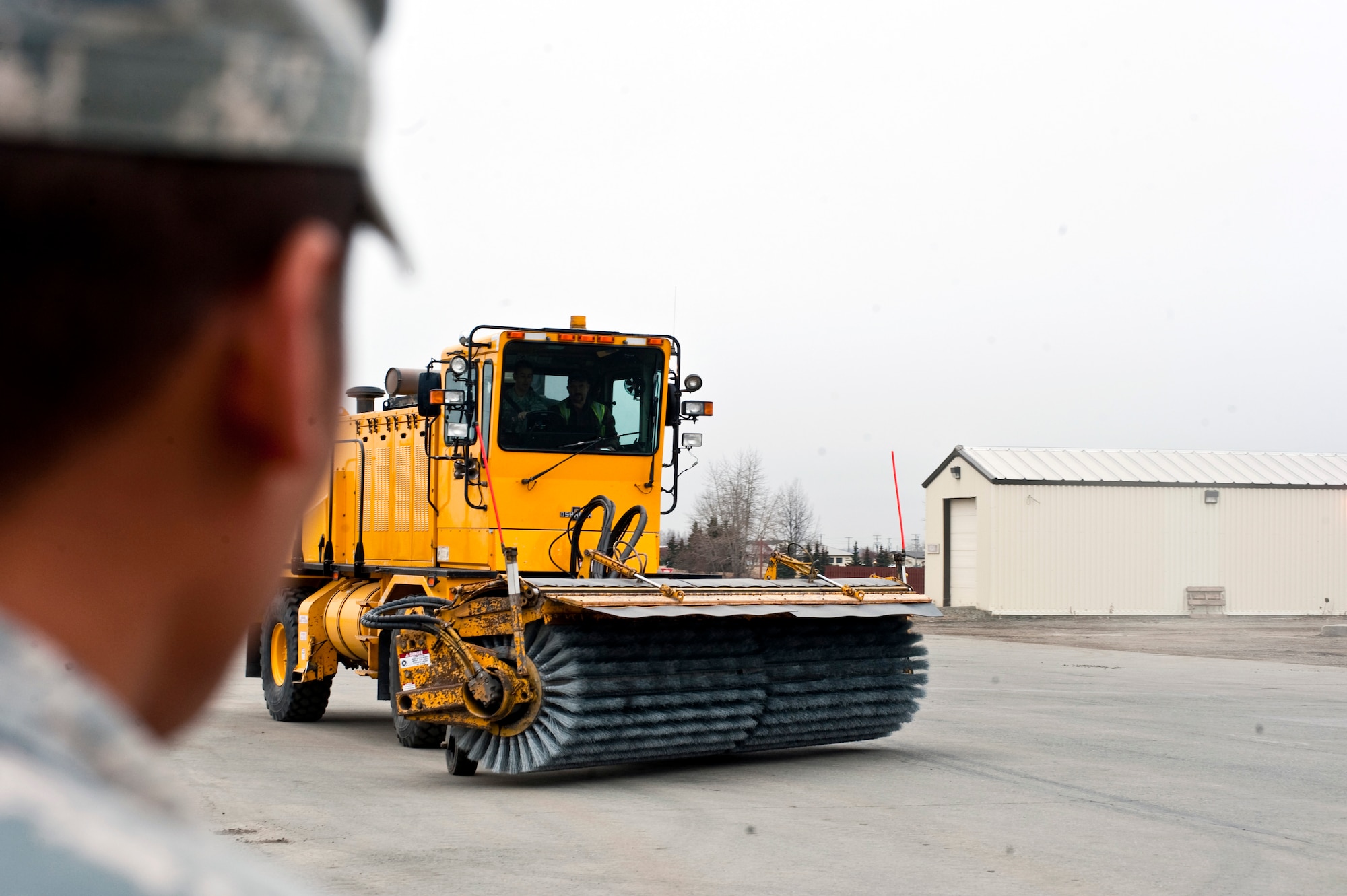 JOINT BASE ELMENDORF-RICHARDSON, Alaska -- Mr. Michael Sanders, 773d Civil Engineer Squadron civilian, instructs Airmen on the differences between the different models of Brooms and how to operate them. The 773d trains Airmen and Soldiers every year in preporation of the winter season. (U.S. Air Force photo/ Airman 1st Class Jack Sanders)