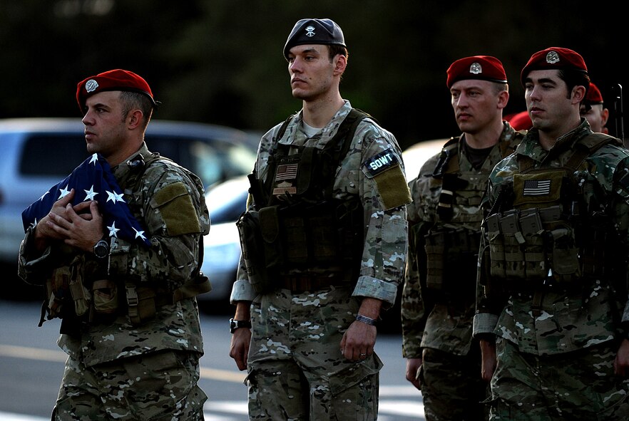 Members of the 320th Special Tactics Squadron deliver the flag to the Veterans Day observation ceremony after completing a memorial run across Kadena Nov. 11. (U.S. Air Force Photo/Staff Sgt. Christopher Hummel)