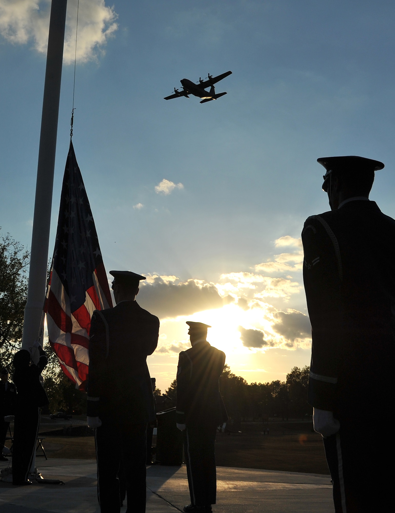 A C-130 flies over the Veterans Day retreat ceremony on base Nov. 10. The base held its retreat ceremony Nov. 10 so the base members could attend off-base Veterans Day services Nov. 11. (U.S. Air Force photo by Staff Sgt. Chris Willis)