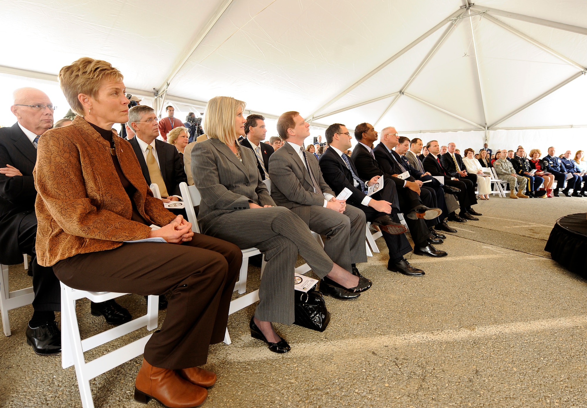 Gail Donley, wife of Secretary of the Air Force Michael Donley, and Suzie Schwartz, wife of Air Force Chief of Staff Gen. Norton Schwartz, listen to speeches during the Fisher House for Families of the Fallen dedication ceremony on Nov. 10, 2010, at Dover Air Force Base, Del.  The Fisher House Foundation built the 50th Fisher House at Dover to support families visiting the base for dignified transfers of their loved ones.  (U.S. Air Force photo/Scott M. Ash)