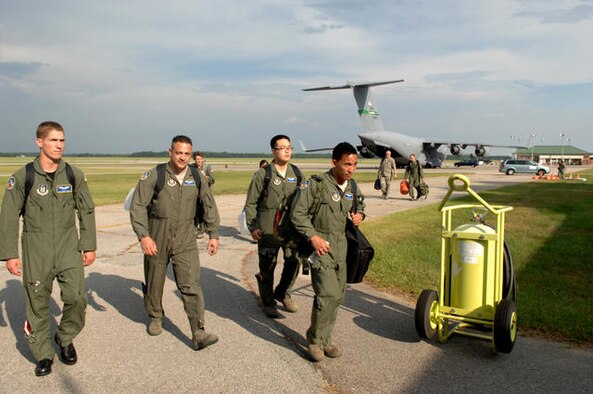 BUSH FIELD, Ga.- From left to right, Senior Airman Zachary Felke, Staff Sgt. Martin Duran, Senior Airman Eun Chun, and Staff Sgt. Robert Molato, all from the 446th Aeromedical Evacuation Squadron, Joint Base Lewis-McChord, Wash., arrive here, July 11, for exercise Global Medic 2010. Reservists from the 446th AES earned the Best Aeromedical Evacuation Squadron Award from Air Force Reserve Command this year. (U.S. Air Force photo by Staff Sgt. Donald R. Allen/)