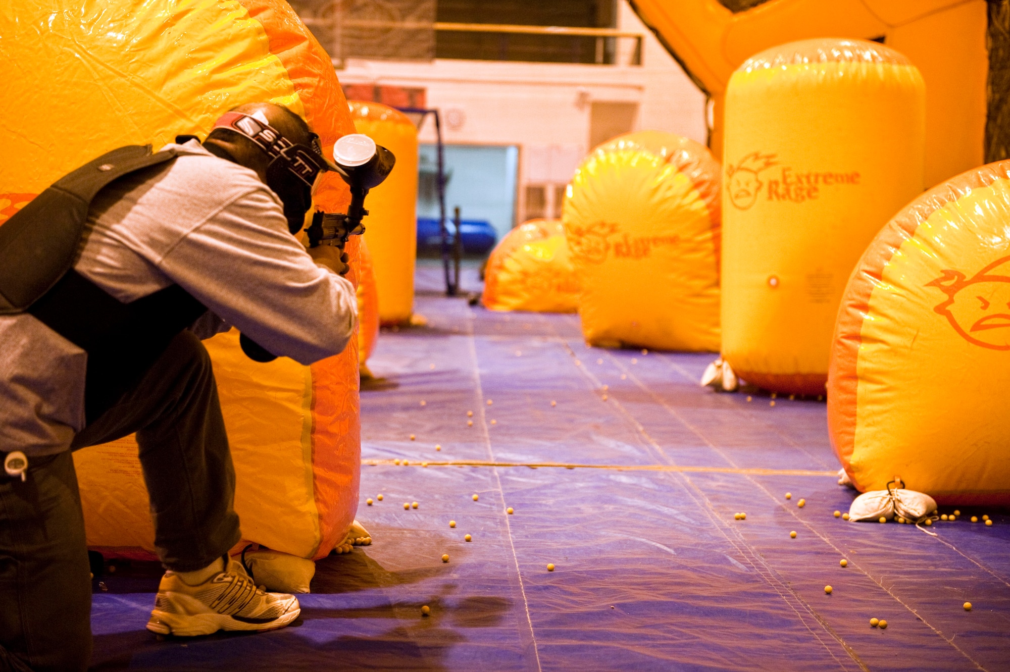 JJOINT BASE ELMENDORF-RICHARDSON, Alaska, -- Marcos Ricco, B Company 425 BSTB, takes aim during a speed ball game with his son and friends Nov. 6.  The Warrior Extreme Paintball course is bringing speed ball, a paintball like sport which uses softer ammunition that stays intact rather than paintballs, to the Buckner Gym on a trial basis. (U.S. Air Force photo/ Airman 1st Class Jack Sanders)