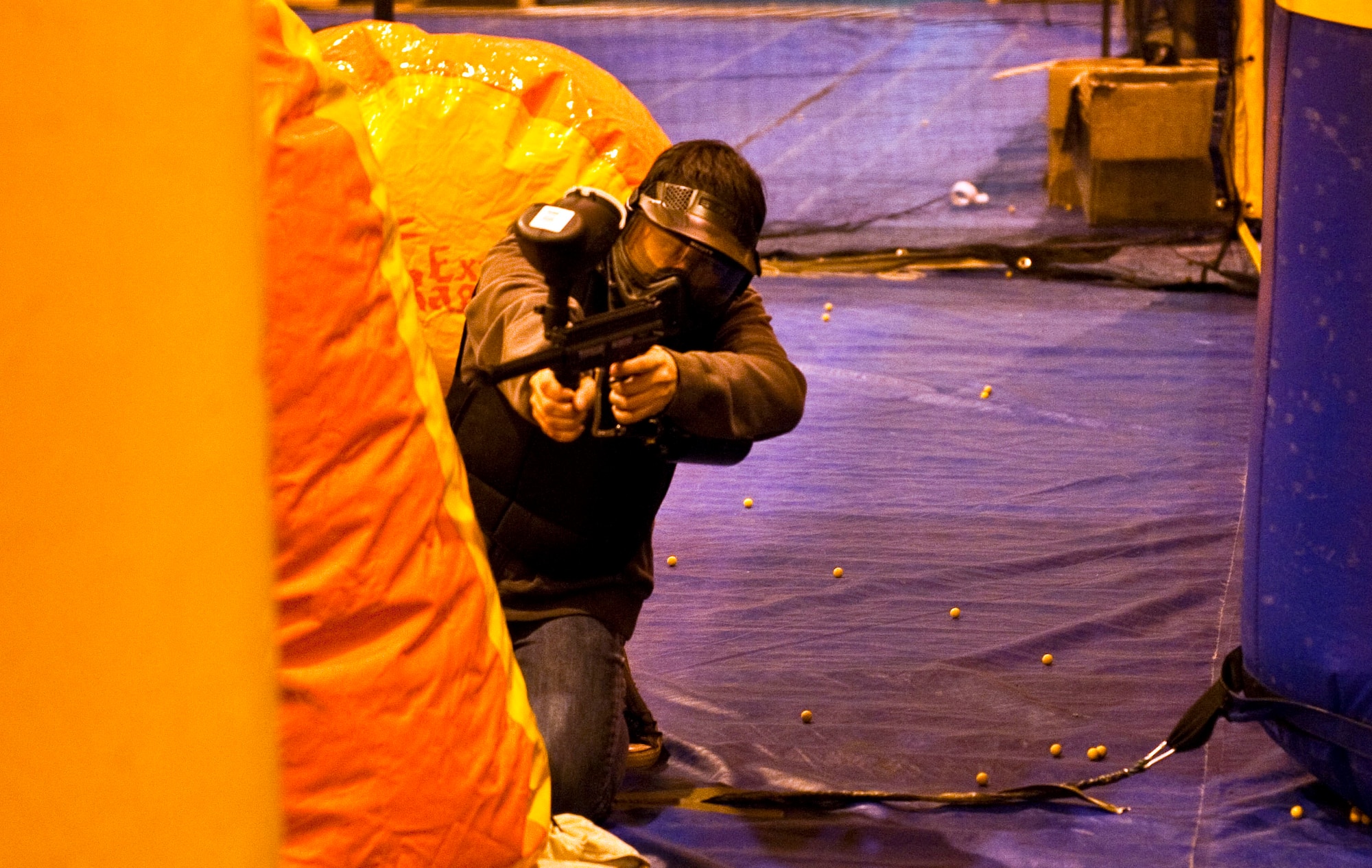 JOINT BASE ELMENDORF-RICHARDSON, Alaska, -- Diego Ricco fires at his opponents during a speed ball game with his father, Marcos Ricco B company 425 BSTB, and friends Nov. 6. The Warrior Extreme Paintball course is bringing speed ball, a paintball like sport which uses softer ammunition that stays intact rather than paintballs, to the Buckner Gym on a trial basis. (U.S. Air Force photo/ Airman 1st Class Jack Sanders)