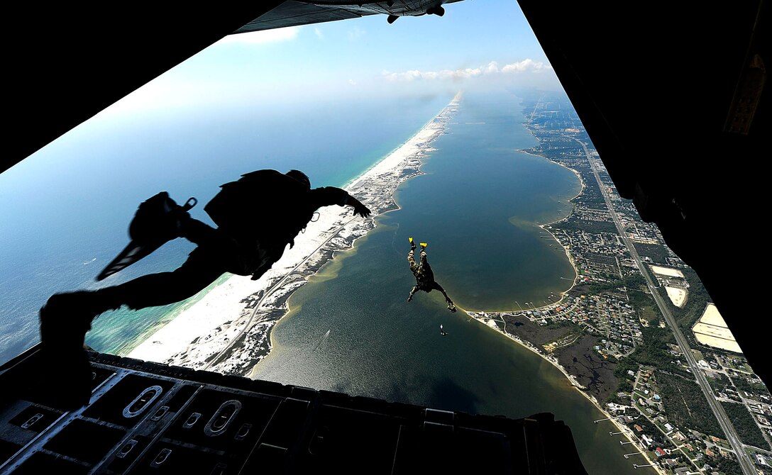 U.S. Air Force members from the Air Force Special Operations Command's 23rd Special Tactics Squadron at Hurlburt Field, Fla., jump out of the back of a C-130 Hercules. The Airmen are practicing combat operations in the Santa Rosa Sound. (U.S. Air Force photo/Master Sgt. Russell E Cooley IV)
