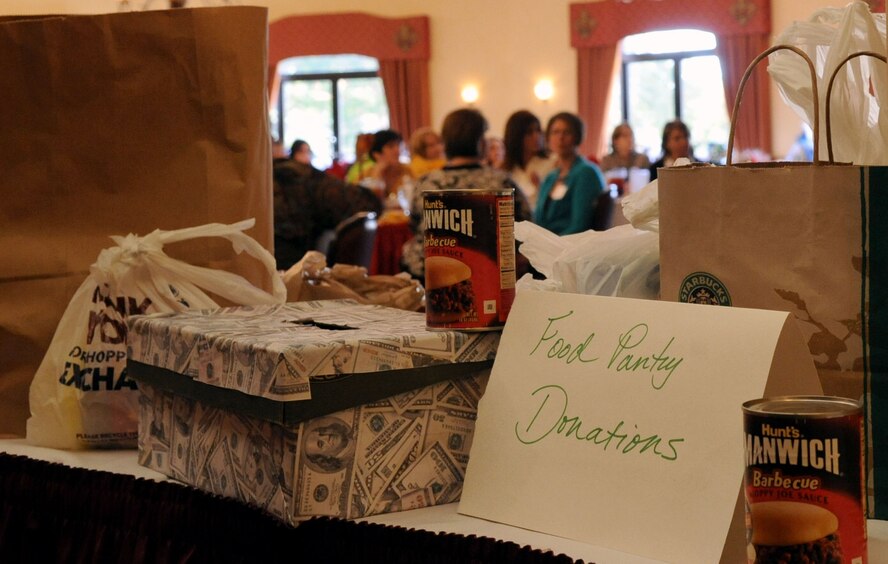 Barksdale Officers Spouses' Club members and guests brought in money, non-perishable and canned goods during the BOSC silent auction luncheon held at the Barksdale Club on Barksdale Air Force Base, La., Nov. 10. All donations collected will be donated to the Northwest Louisiana Food Bank. (U.S. Air Force photo/Senior Airman La'Shanette V. Garrett) (RELEASED)