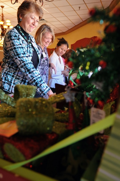 Members of the Barksdale Officers Spouses' Club look over and bid on a variety of baskets donated by different club members, guests and squadrons from Barksdale, Shreveport and Bossier City during the BOSC silent auction luncheon held at the Barksdale Club on Barksdale Air Force Base, La., Nov. 10. The BOSC is a private non-profit organization for officers' spouses. Their mission is to create a supportive, comfortable arena for members to explore social connections, volunteer activities and educational opportunities. (U.S. Air Force photo/Senior Airman La'Shanette V. Garrett)(RELEASED)