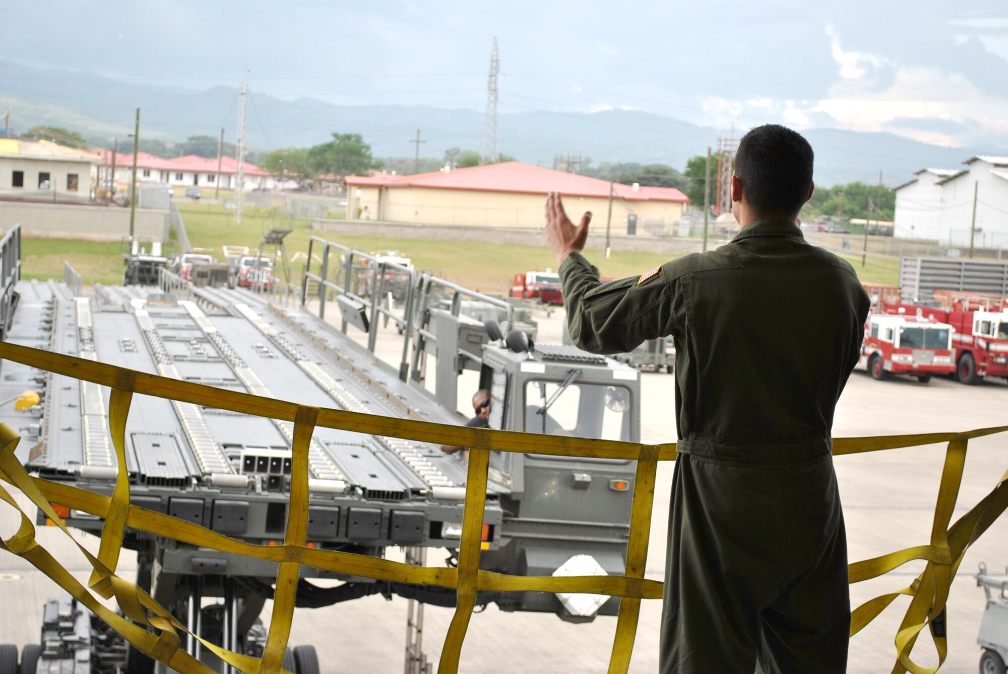 KC-10 Extender aircrew member from Joint Base McGuire-Dix-Lakehurst, N.J., guides in a Tunner close to the doors of the aircraft in order to unload pallets Oct. 25, 2010, at Soto Cano Air Base, Honduras. Two KC-10s from JB McGuire-Dix-Lakenhurst delivered 18 tons of humanitarian aid to be delivered to local charities. (U.S. Air Force photo/Staff Sgt. Andre De La Torre)