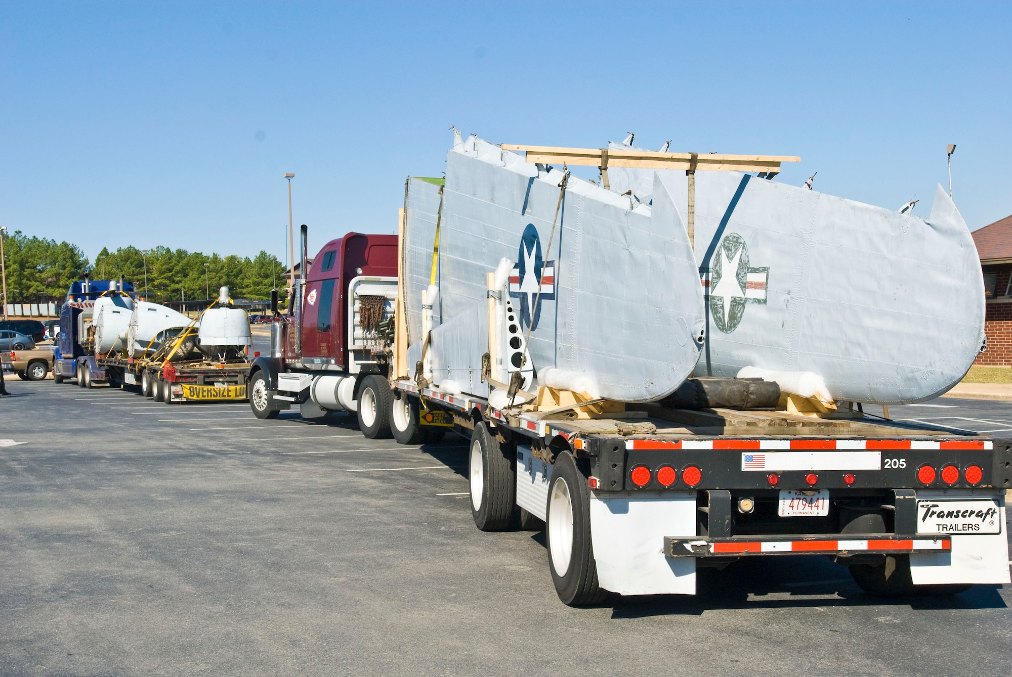 Semitrailers carry parts of a C-47 Skytrain static display Sept. 30 to Little Rock Air Force Base. The aircraft is now the latest edition to the Heritage Park displays and is painted in a World War II scheme. (U.S. Air Force photo by Staff Sgt. Nestor Cruz)