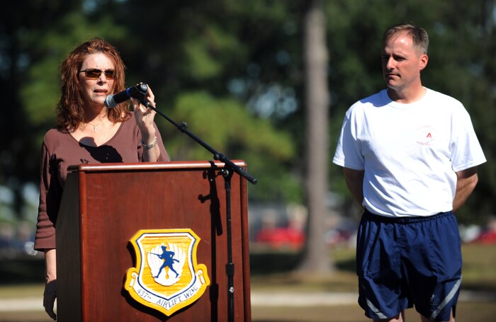 Carmen Mikolajcik, joined by Col. John Wood, gives her welcoming remarks prior to the start of the second annual Run the Runway 5K event honoring Brig. Gen. (Ret.) Thomas Mikolajcik Nov. 10, 2010, on Joint Base Charleston, S.C. Prior to the start of the run, a check was donated to the Amyotrophic Lateral Sclerosis Association. Mrs. Mikolajcik is the surviving spouse of the general, and Colonel Wood is the 437th Airlift Wing commander. (U.S. Air Force photo/Senior Airman Timothy Taylor)