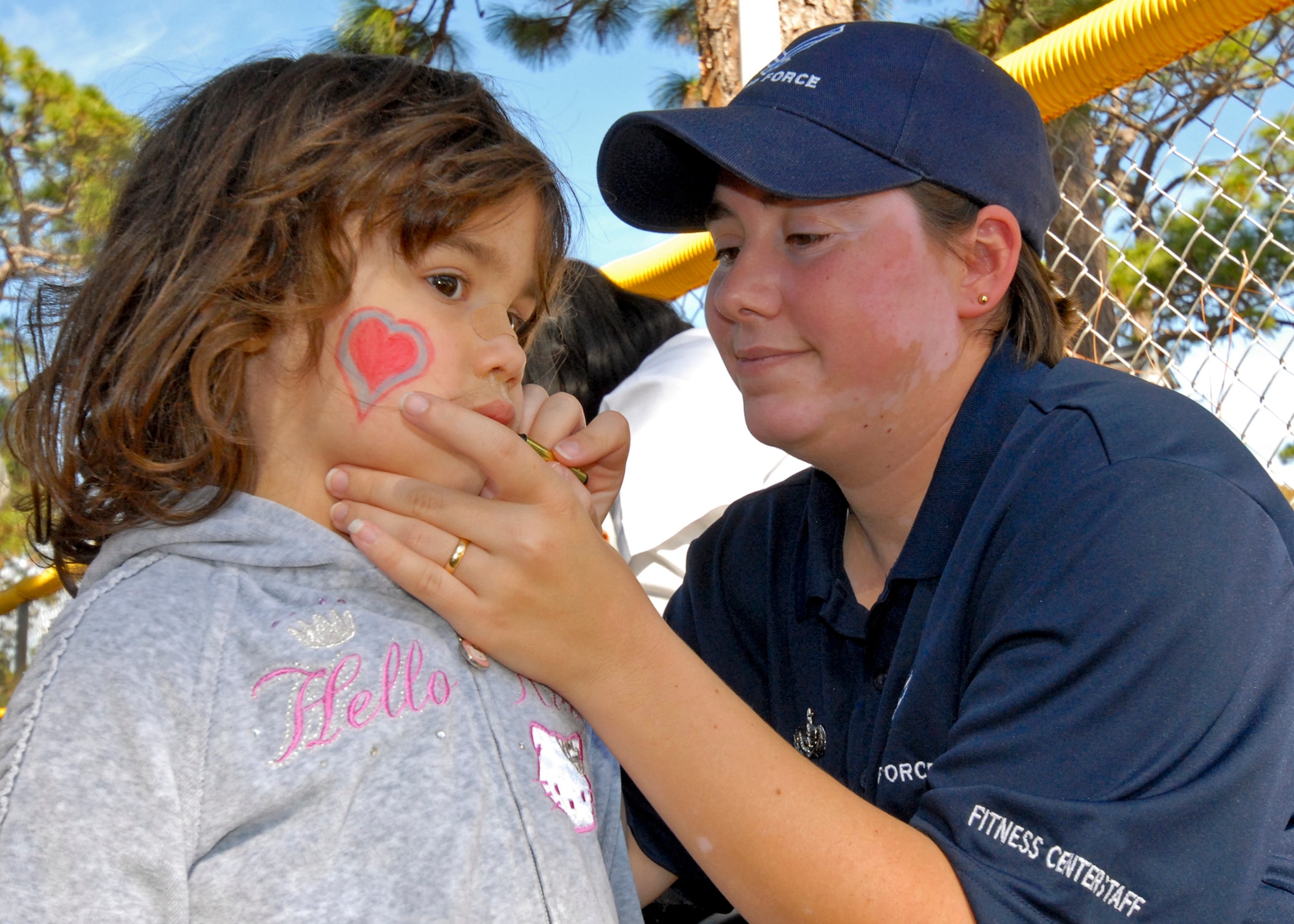 Staff Sgt. Gail King, 96th Force Support Squadron, paints Kaylin Gonzalez's face at the Child Development Center Fall Festival Nov. 10. The annual festival celebrated the Month of Military Families. (U.S. Air Force photo/Sachel Seabrook) 

