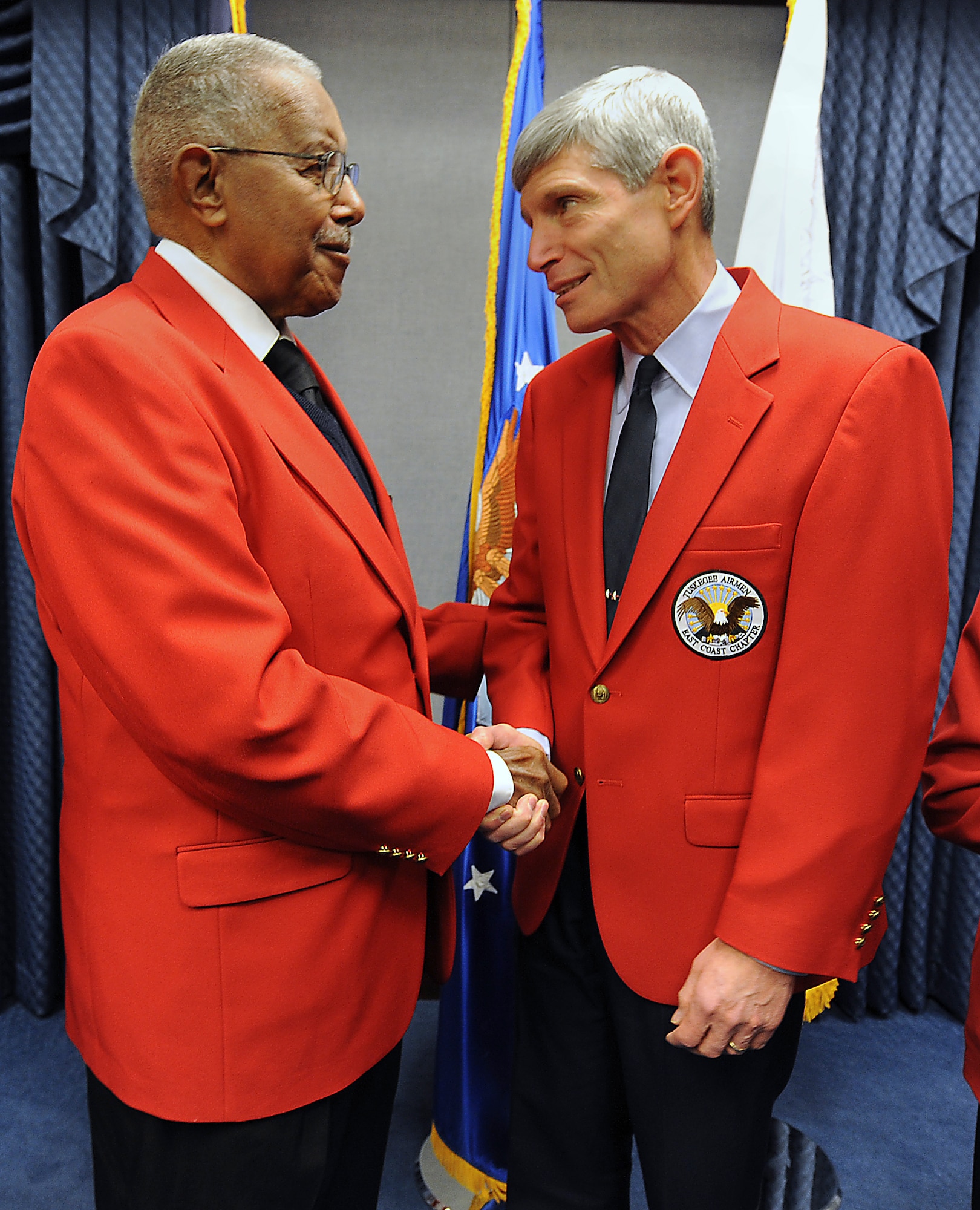 James Pryde, an original Tuskegee Airman and former radio operator, congratulates Air Force Chief of Staff Gen. Norton Schwartz after Tuskegee Airmen Incorporated officials presented the general an honorary membership in the organization on Nov. 9, 2010, at the Pentagon.  Six original Tuskegee Airmen were present during the brief ceremony in which General Schwartz was presented with his Tuskegee Airmen red jacket.  General Schwartz joins Gen. Merrill McPeak and Gen. Ronald Fogleman as the only Air Force chiefs of staff to be recognized with the honorary membership.  (U.S. Air Force photo/Scott M. Ash)