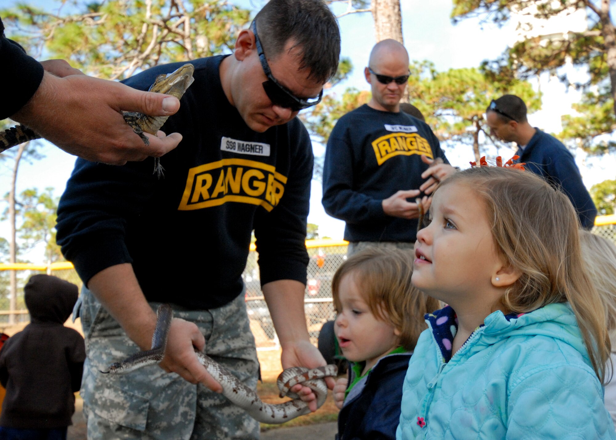Two-year-old Adalyn Zuber get up close and personal with Carlos, the 6th Ranger Training Battalion’s alligator at the Child Development Center Fall Festival Nov. 10. The annual festival celebrated the Month of Military Families. (U.S. Air Force photo/Sachel Seabrook)

