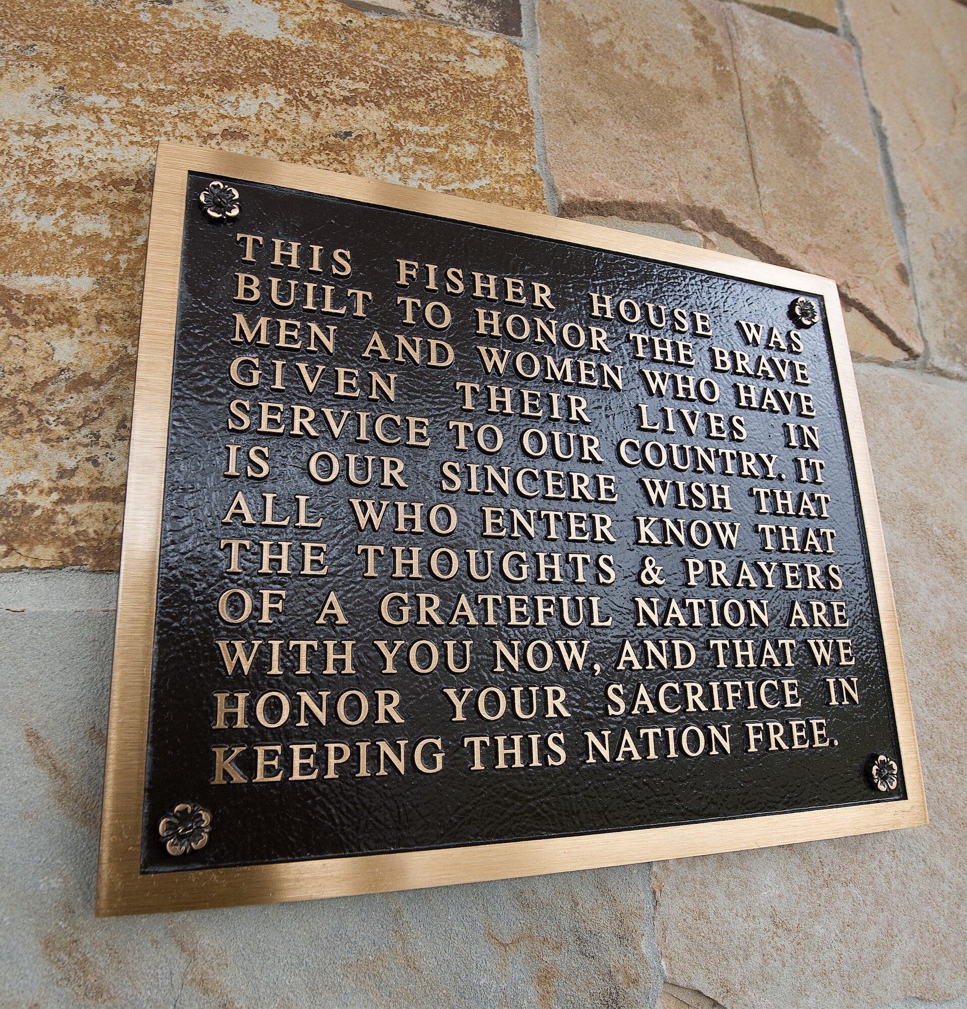 The plaque located outside the main door to the Fisher House for Families of the Fallen as a tribute to the families who stay there. "The thanks of a grateful nation will be the brick and mortar that hold these houses together," said Ken Fisher, Chairman of Fisher House Foundation during the dedication ceremony Nov. 10, 2010. (U.S. Air Force photo/Jason Minto) 