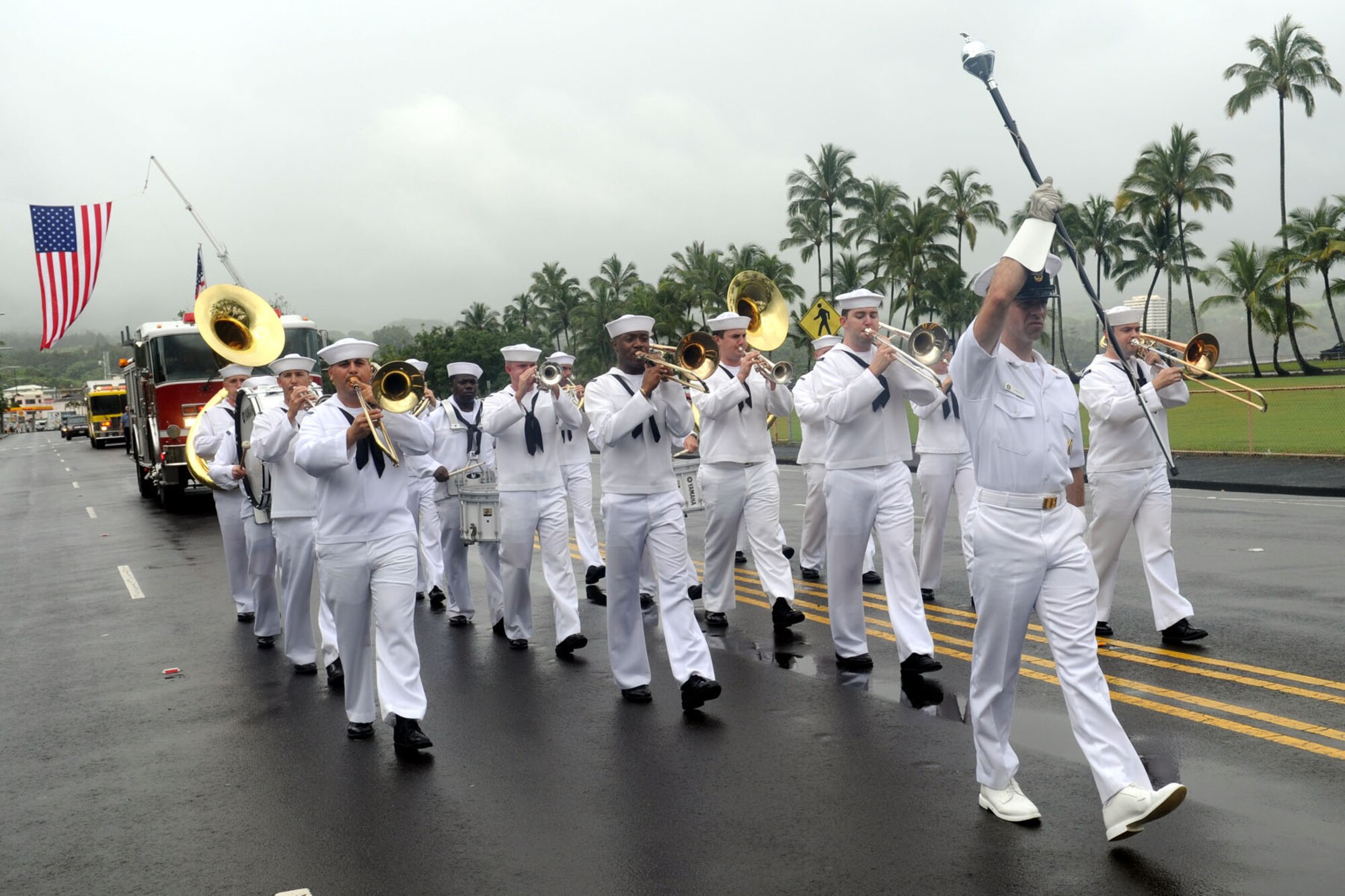 The Naval Pacific Fleet Band performs while marching through the streets during the 2010 Big Island Veterans Day Parade in Hilo, Hawaii, Nov. 6, 2010. City officials invited the National Security Agency/Central Security Service Joint Service Color Guard and the Naval Pacific Fleet Band to participate in the parade that day. (U.S. Air Force photo/Tech. Sgt. Jerome S. Tayborn)