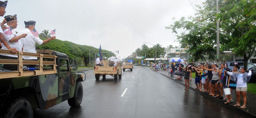 Veterans proudly wave American flags as their Humvees ride past island residents Nov. 6, 2010, during the 2010 Big Island Veterans Day Parade in Hilo, Hawaii. (U.S. Air Force photo/Tech. Sgt. Jerome S. Tayborn)